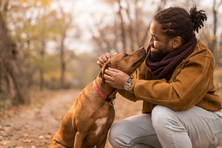 man with dog sitting